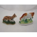 Two miniature Staffordshire figures cow and cat