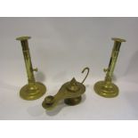 A pair of brass ejector candlesticks and an Islamic brass lantern