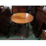 An oak old charm circular top occasional table on stretcher base,