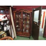 A South African hardwood full height glazed display cabinet with shelved interior, twin drawer base,