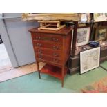 An Edwardian mahogany four drawer music cabinet with line inlay decoration and undertier,