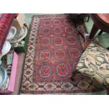 A red and blue ground lozenge design rug, multiple borders and tasselled ends, worn,