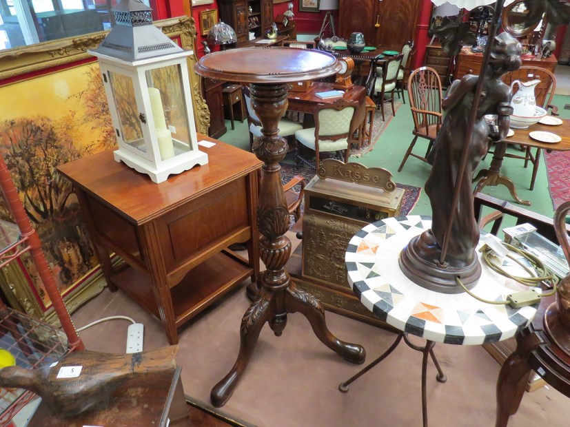 A Georgian style walnut jardiniere stand the carved and fluted column on a tripod base,