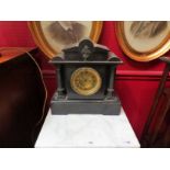 A slate mantel clock of architectural form with brass Roman numerated dial