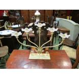 A cream five sconce candle stand with glass drip trays,
