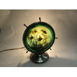 A retro lamp with fish scene in the shape of a ships wheel