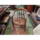 An Edwardian inlaid mahogany desk chair with pierced splat back rest over brass stud border leather