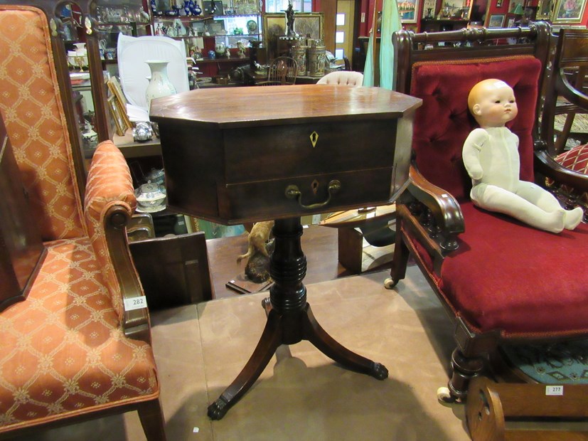 A George III mahogany worktable the canted corner top and single frieze drawer over a ring turned