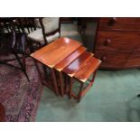 A modern brass inlaid nest of four tables with floral detailing