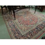 A Persian beige, red and blue ground early 20th Century rug,