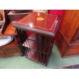 A Georgian style crossbanded inlaid mahogany revolving bookshelf on castors,