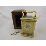 A French brass carriage clock with original travel case (with front cover), and key.