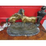 A bronzed figural group depicting two horses on rocky terrain, signed P.J.