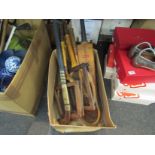 A box containing vintage sporting equipment, tennis rackets,