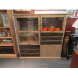 A modern hardwood cupboard with three doors and six drawers,