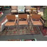 A set of four tan faux leather and chrome effect directors chairs,