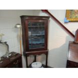 A mahogany astragal glazed corner cupboard on stand, crack to glass,