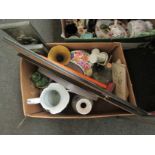 A box containing prints, plaster wall hangings, studio pottery etc.