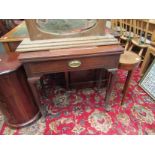 A Victorian mahogany tea/card table with fold-over top and oval brass plate handle,
