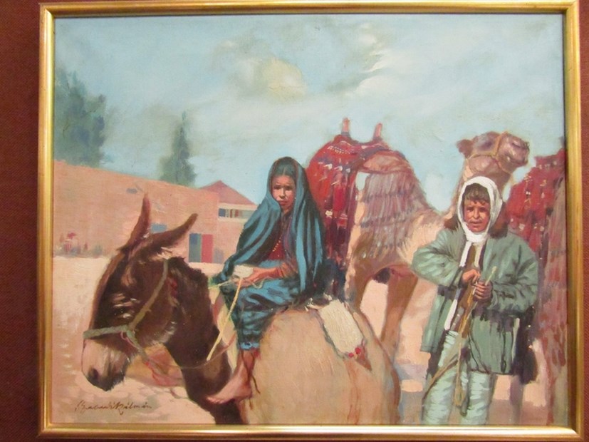 A 20th Century oil on canvas, middle Eastern School, woman riding a donkey with man leading a camel.