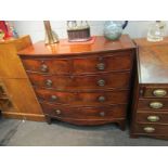 A Victorian mahogany bow front two over three chest of drawers, handles missing,