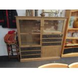 A modern hardwood cupboard with three doors and six drawers,