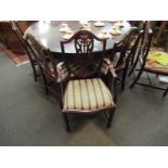 A set of ten reproduction mahogany shield back chairs with H stretchers, drop-in seats,