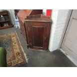 A 19th Century oak corner cupboard with raised gallery back,