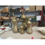 Four signed Arabic Dallah brass coffee pots with leather bound handles