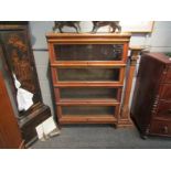 A Globe Wernicke oak bookcase with four sections of glass fronted shelving,