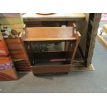 A medium oak book trough with under tier and pierced ends.