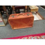 A vintage tan leather suitcase