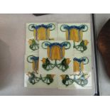 A set of five floral design ceramic tiles