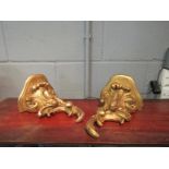 A pair of gilt carved floral design wall brackets