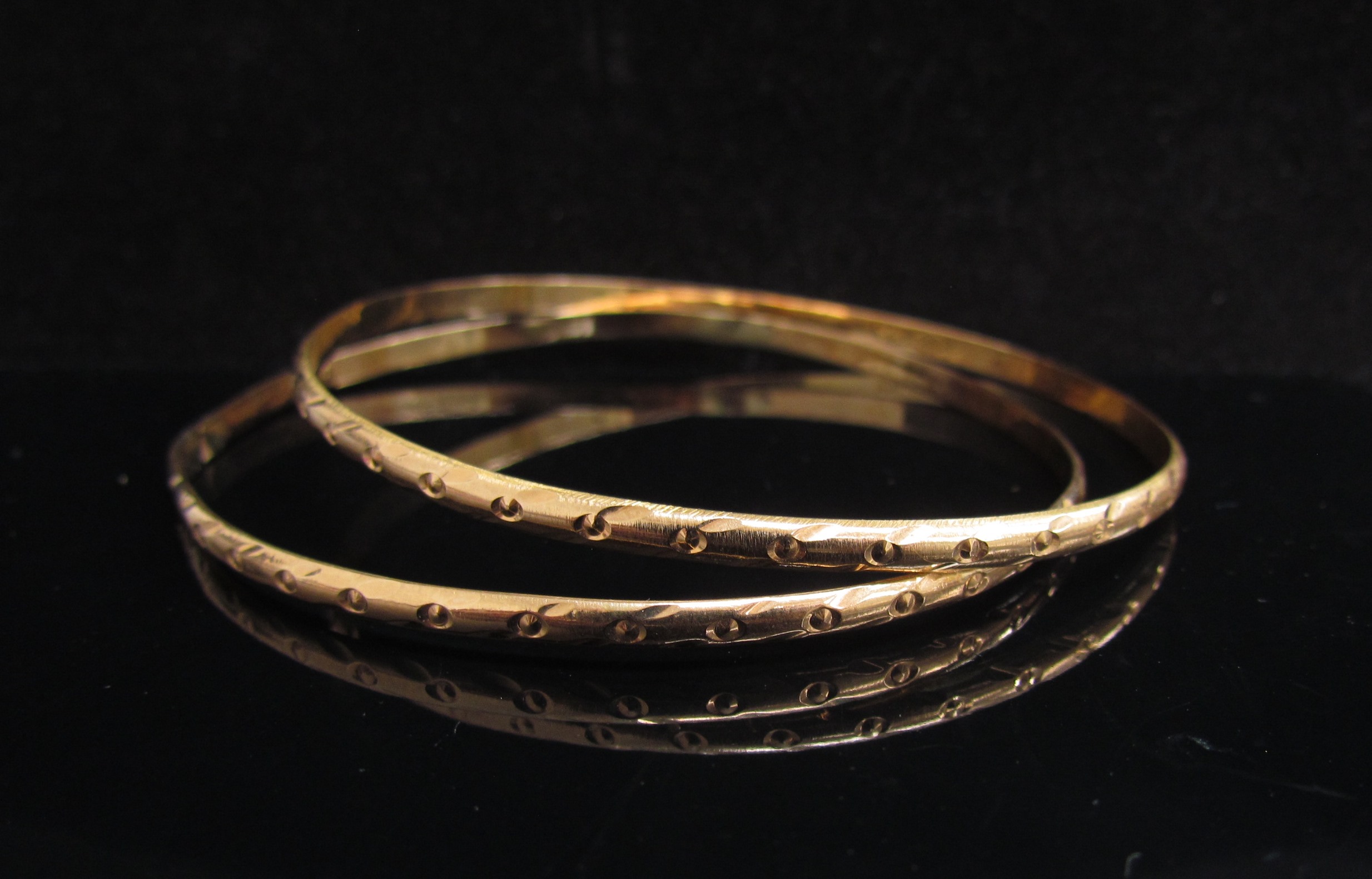 Two gold bangles, one repaired, unmarked, 7.2g