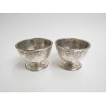 A pair of early Victorian silver table salts, scrolled relief border, marks rubbed,