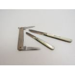 Three silver folding pen/fruit knives, two with silver blades and mother of pearl handles,