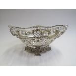 A late Victorian pierced silver boat shaped bread basket on a pierced Rococo style foot.