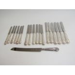 A set of six Elizabeth II silver handled King's pattern tea knives with stainless steel blades.