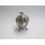 An Indian white metal tea caddy of lobed gourd shape, raised upon three hairy paw feet,