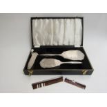 An Elizabeth II silver backed four piece dressing table set of hand mirror, hair brush,