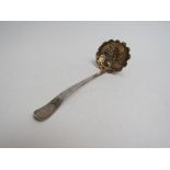 A Victorian silver berry sifter ladle with gilded bowl and foliate engraved handle. London 1864.