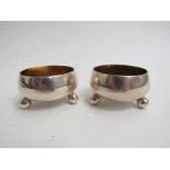 A pair of Victorian silver cauldron salts, each of plain circular form with gilded interior,