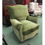 Circa 1860 a green crushed velvet upholstered armchair the feather filled cushions and scroll arms