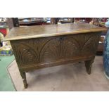 An 18th Century carved elm coffer of small proportions on shaped sides,