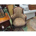 A Victorian mahogany armchair with carved relief on turned and reeded tapering legs with Paisley