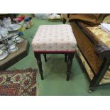 A mid Victorian mahogany stool on ring turned tapering legs