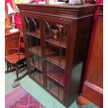 A "Rosjohn" George III style mahogany astragal glazed two door bookcase with height adjustable