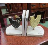 A pair of wooden book ends with chicken design
