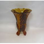 A Deco amber coloured glass vase on tripod feet,